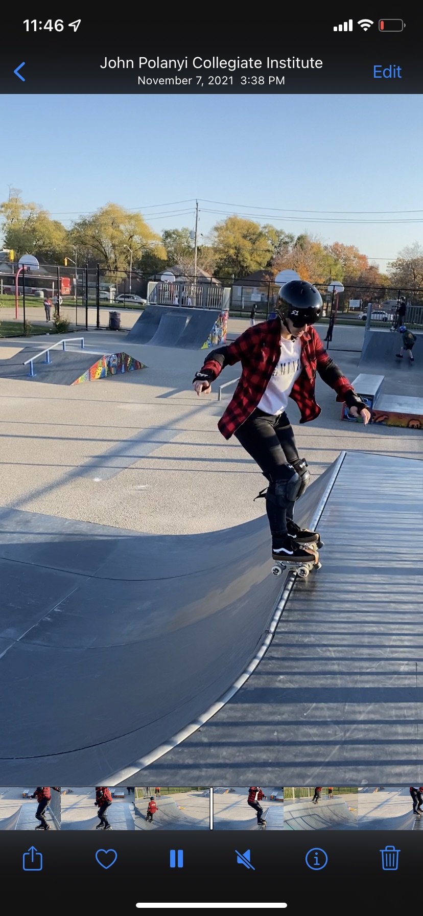 In this image, Allison skates along the edge of a ramp at a skate park. She is wearing roller skates.