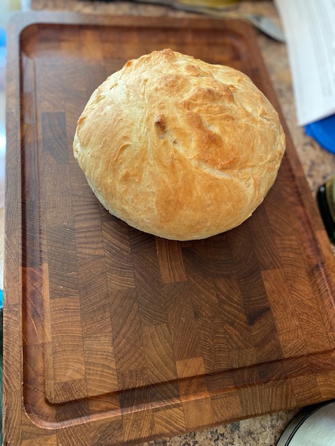 A round loaf of bread looking scrumptious on a cutting board.