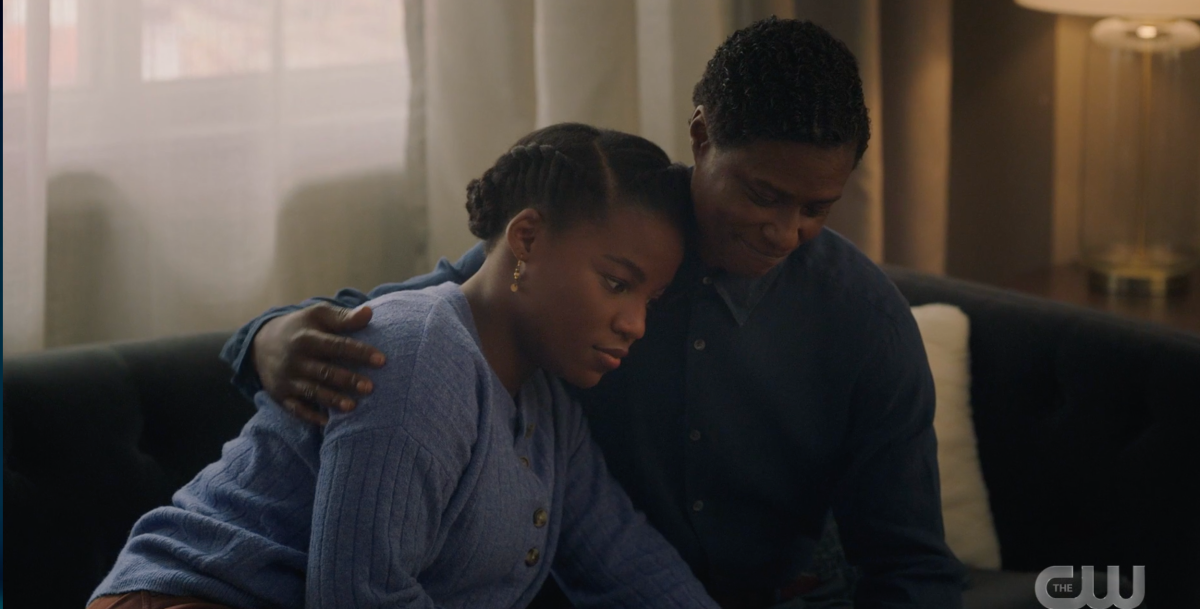 While they are sitting on the couch, Shanice lays on Docs shoulder while he puts his arm around her and has a smile.