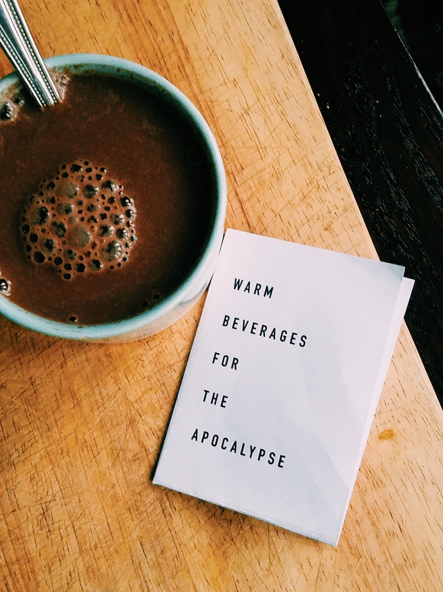 A zine that reads simply, "Warm Beverages for the Apocalypse" next to a warm chocolatey looking beverage.