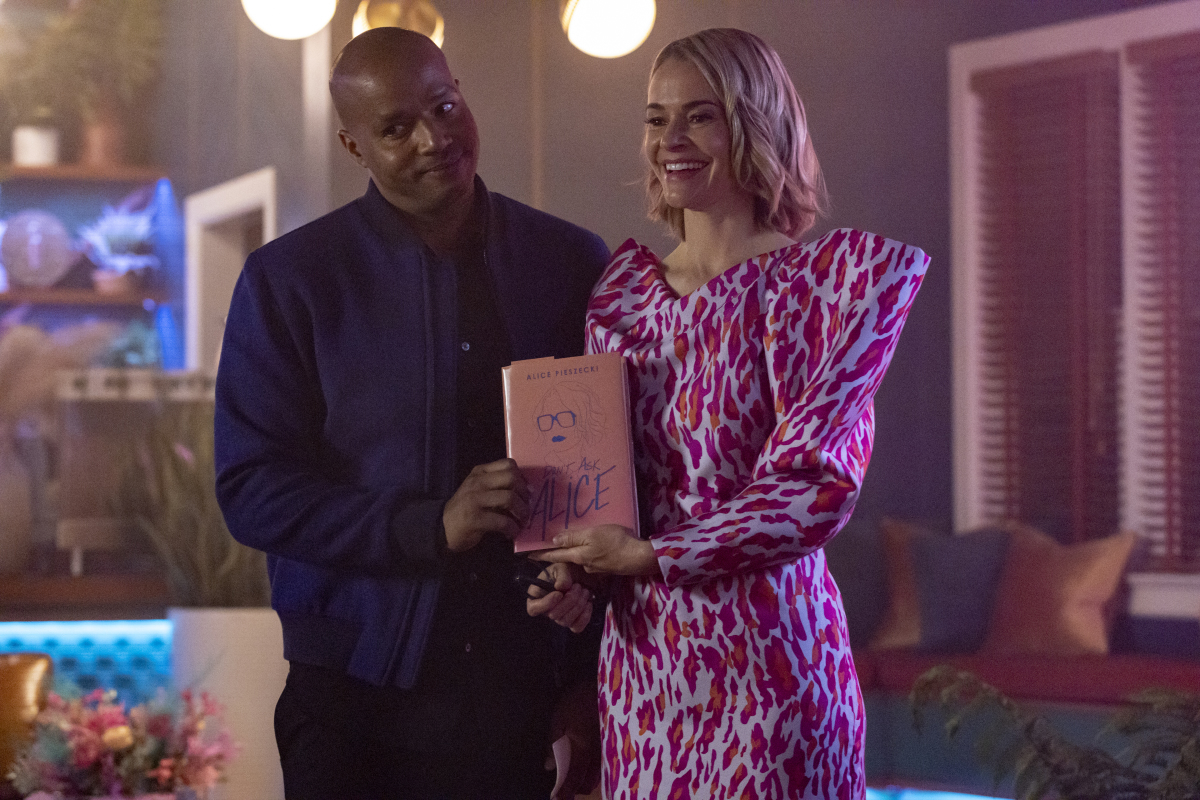 Alice and Tom posing with her book