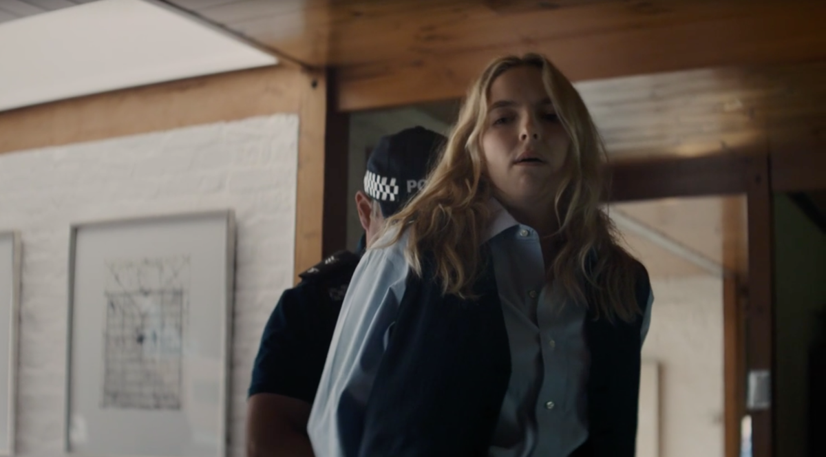 Villanelle is wearing a suit and being arrested on Killing Eve