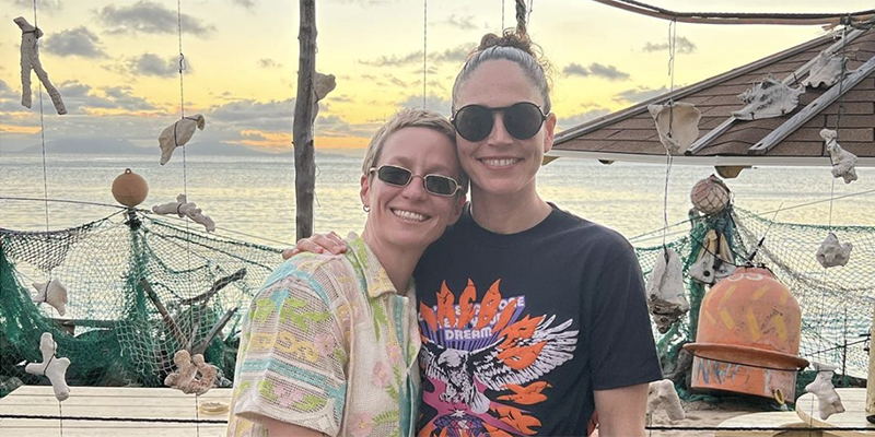 Sue Bird with her arm around Megan Rapinoe on the beach