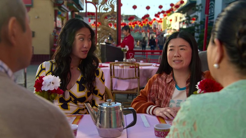 Alice and Sumi sit opposite Alice's mother and father for lunch outside at a Chinese restaurant.