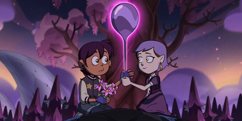 Luz and Amity hold a balloon together