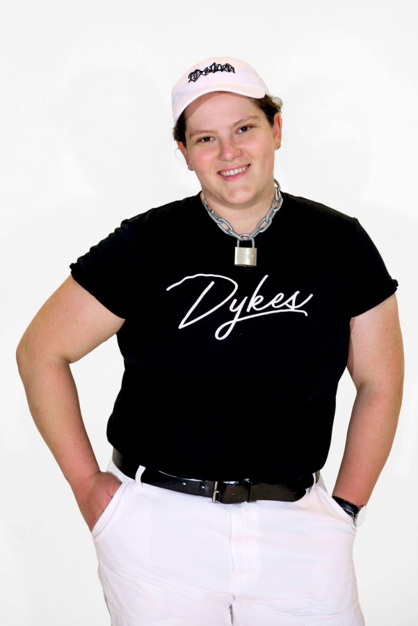 A model is wearing the Team Dykes Black Tee in Size XL