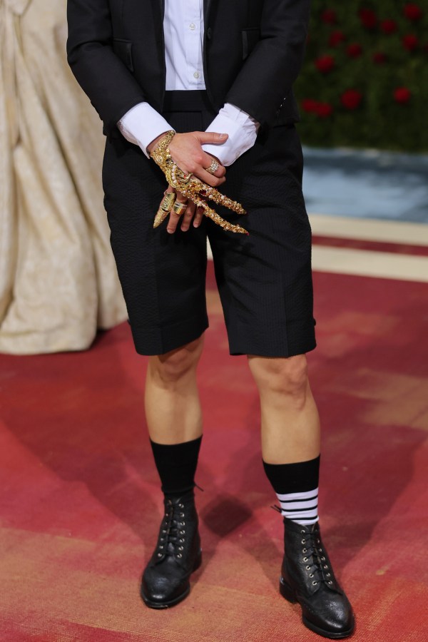 A close up of Melissa King's knee length black tuxedo shorts with calf high black socks, one sock has white stripes