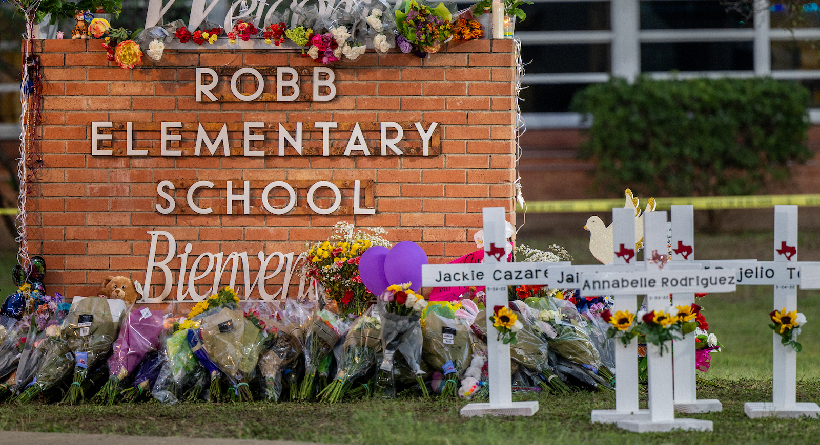 UVALDE, TEXAS - MAY 26: A memorial is seen surrounding the Robb Elementary School sign following the mass shooting at Robb Elementary School on May 26, 2022 in Uvalde, Texas. According to reports, 19 students and 2 adults were killed, with the gunman fatally shot by law enforcement. (Photo by Brandon Bell/Getty Images)