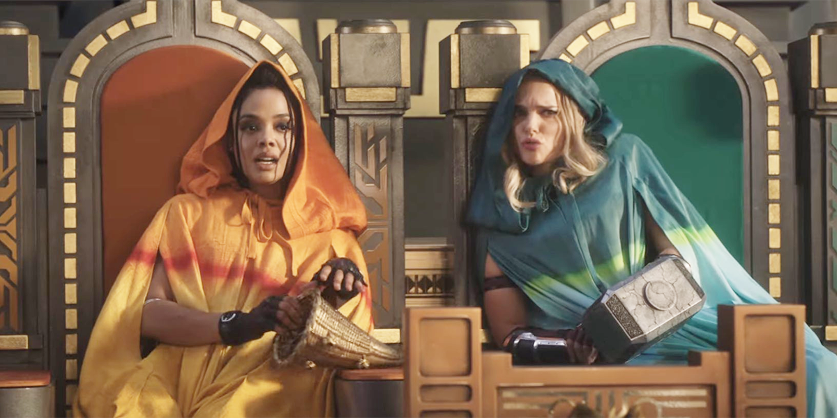 Valkyrie and Jane sit together in colorful cloaks on thrones in Thor: Love and Thunder