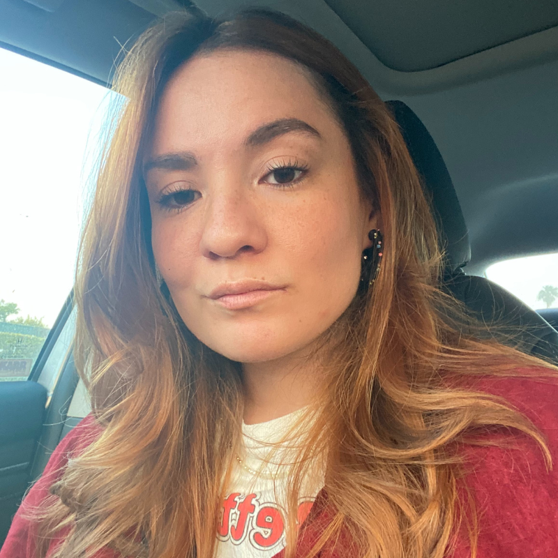 Analyssa is a mixed race Latina with ombre blonde highlights in her hair, she’s giving a confident look sitting in her car.