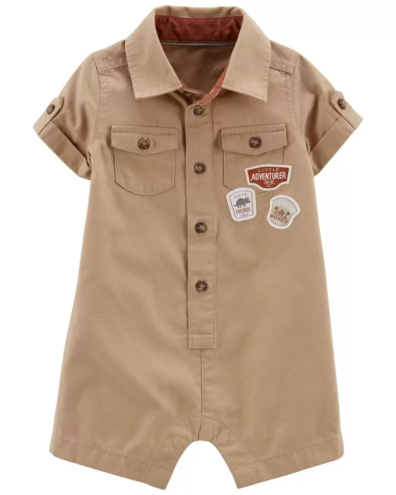 This is a baby outfit that is essentially a canvas colored onesie with a "little adventurer" patch on it. It's like a collared coverall look.