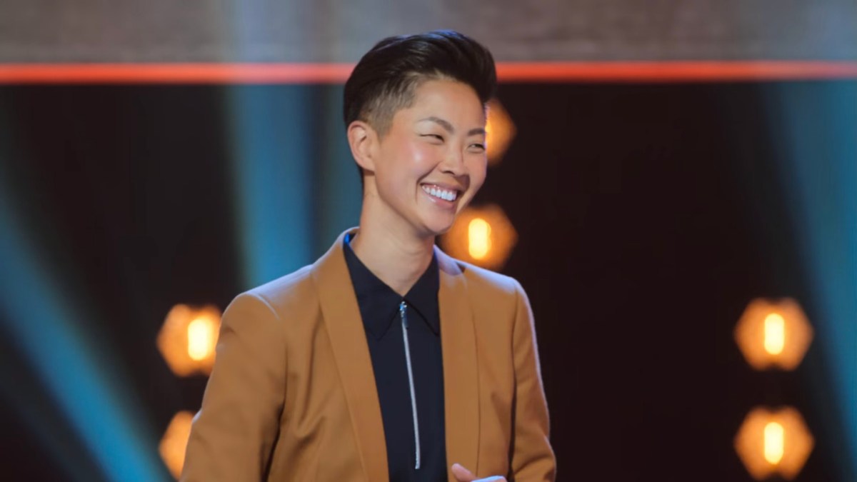 Kristen Kish in a tan suit with a black zipper shirt