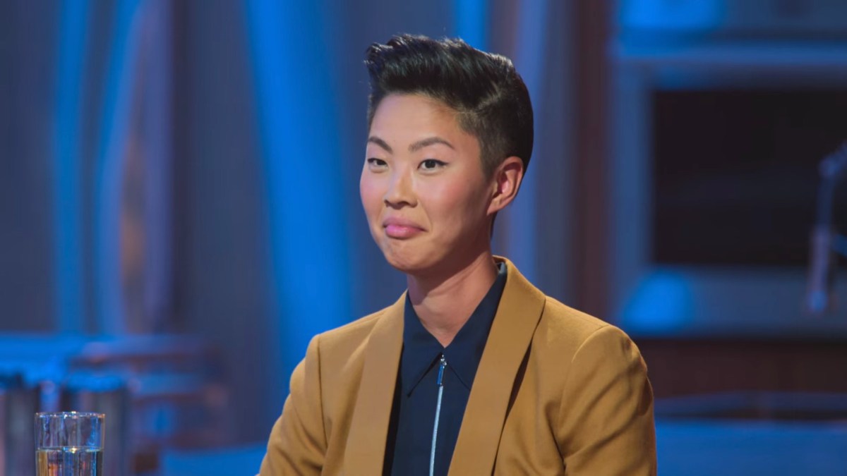 Kristen Kish in a tan suit with a black zipper shirt