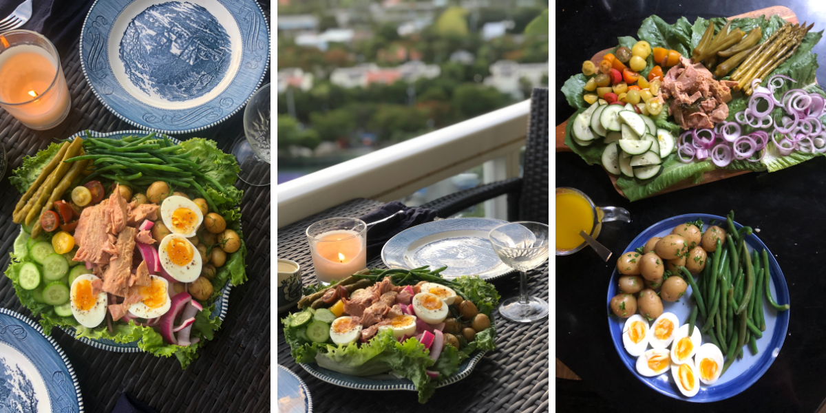 Photo 1: A tuna nicoise on a blue and white plate. The salad features green beans, pickled asparagus, medium boiled eggs, pickled red onions, baby potatoes with dill, sliced cucumber, sliced multicolor cherry tomatoes, green beans, romaine lettuce, and a pile of tuna. There is a candle lit on the table and a coupe glass of wine. Photo 2: A tuna nicoise on a blue and white plate. The salad features green beans, pickled asparagus, medium boiled eggs, pickled red onions, baby potatoes with dill, sliced cucumber, sliced multicolor cherry tomatoes, green beans, romaine lettuce, and a pile of tuna. There is a candle lit on the table and a coupe glass of wine. A blurry view of Miami is visible in the background. Photo 3: A tuna nicoise on a wood board and blue plate. On the blue plate, there are potatoes dressed in parsley, medium boiled eggs, and green beans. On the wood board, there's romaine lettuce, raw red onion, sliced cucumber, sliced multicolor cherry tomatoes, pickled asparagus, pickled okra, and a pile of tuna with jalapeño. There's also a small measuring cup full of dressing.