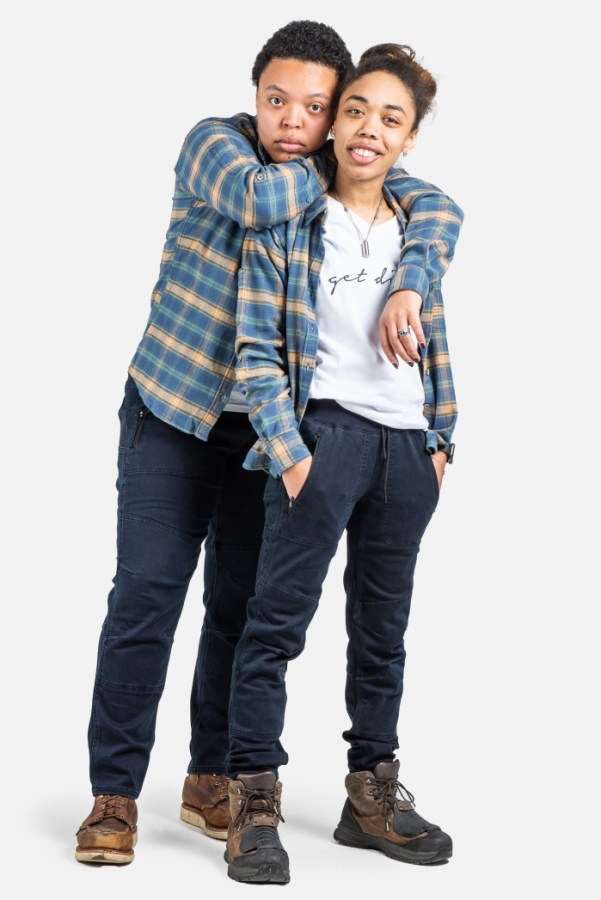 two Black models show off plaid shirts, work pants and work boots from dovetail workwear