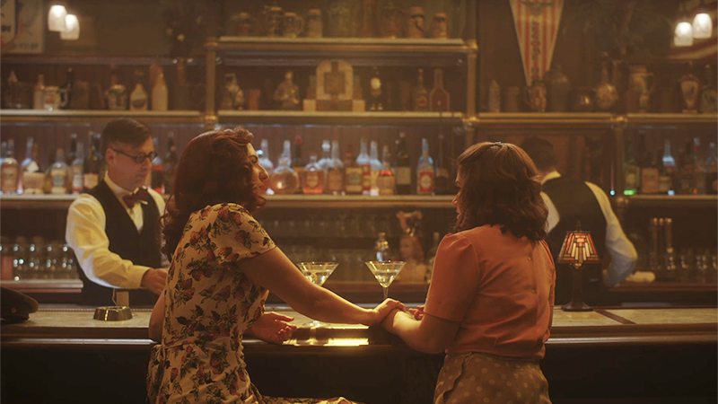 A League of Their Own Recap: Greta holds Carson's arm at the bar. 