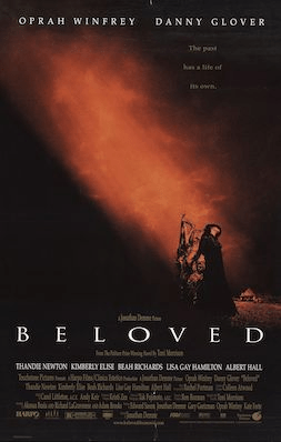 the cover of beloved shows two characters in the glow of an orange beam of light against a very dark background