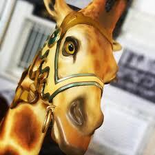 a close-up of a giraffe carousel steed