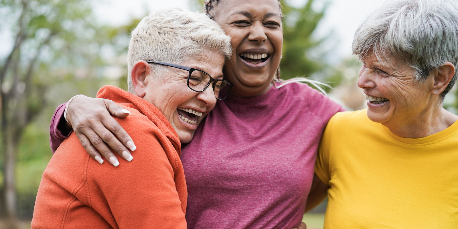 three older women laughing and having a good time together