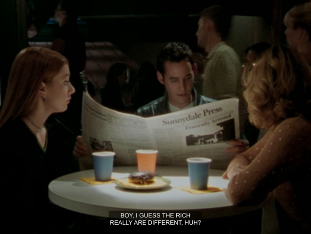 Willow, Xander and Buffy sitting around a table in the Bronze. Xander is reading a paper and saying “boy, I guess the rich really are different, huh!