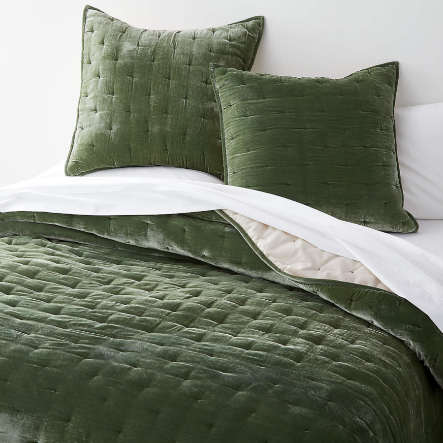 Green velvet pillows with a matching green velvet quilt