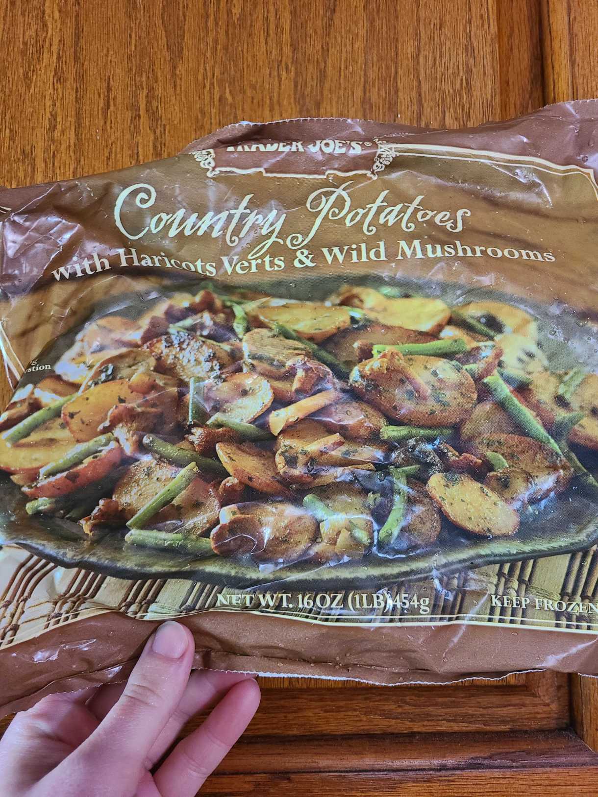 nico holding a package of country potatoes from trader joes
