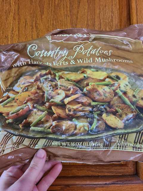 nico holding a package of country potatoes from trader joes