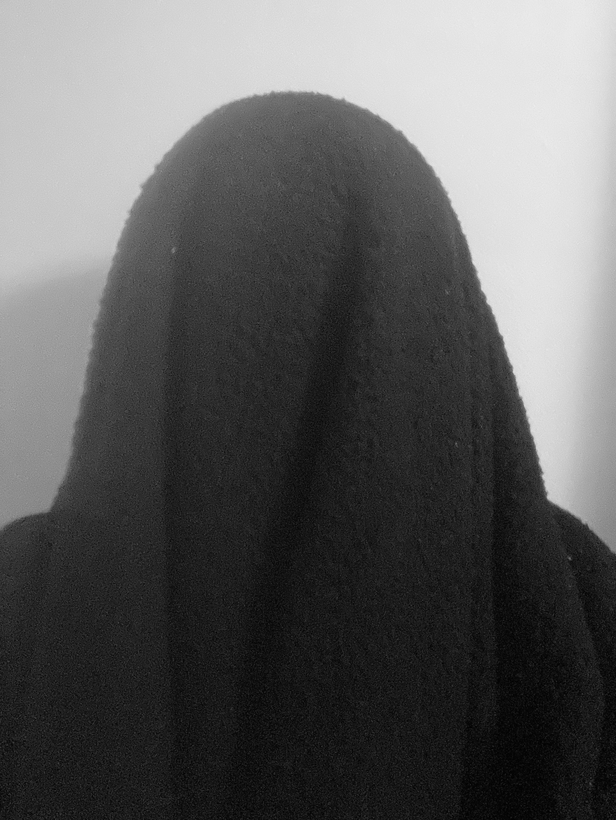 Ro is under a black blanket completely like a ghost
