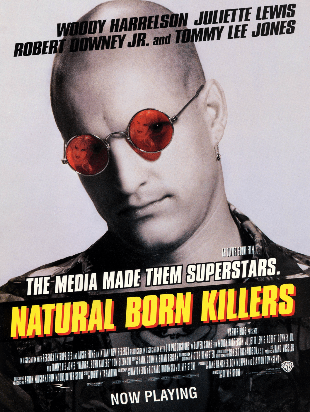 the cover of natural born killers featuring a man with a shaved head and red sunglasses