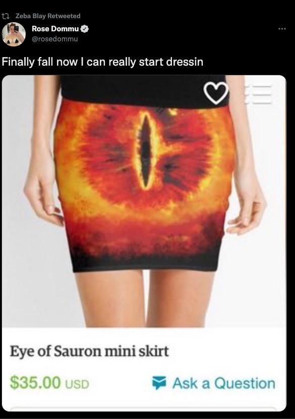 a tweet that says "finally fall now I can really start dressin" and it shows a mini skirt on a model with the eye of sauron right in the center, the slit lining up between the model's hips