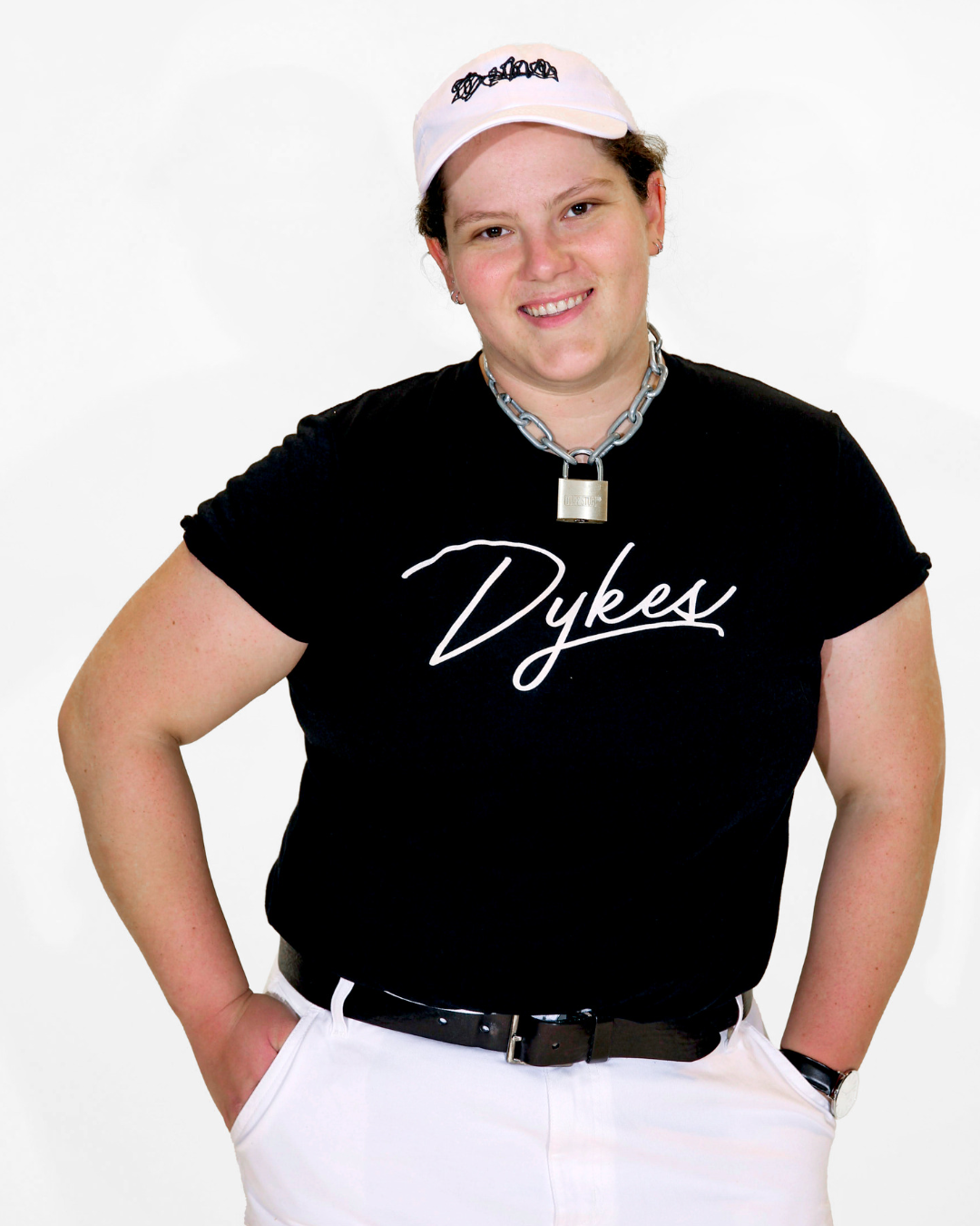 Model Jenny is wearing the Team Dykes Black Tee in size XL. They are 5'9" and their bra size is 38DDD. The tee is black with the text "Dykes" in white color to resemble a hand-drawn signature.