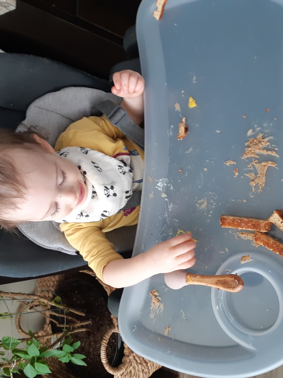 baby jimena eats at a high chair