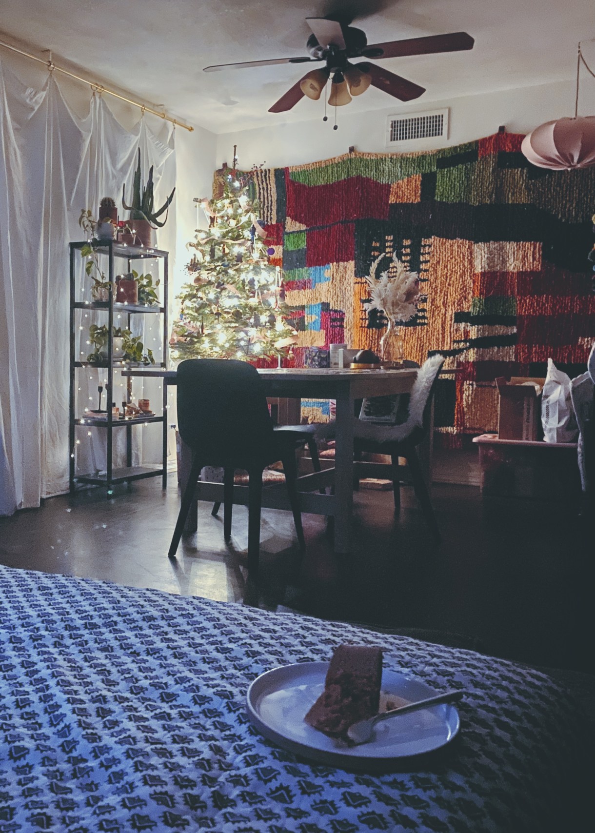 laneia's eclectically decorated apartment in the background and a partially eaten piece of cake in the foreground