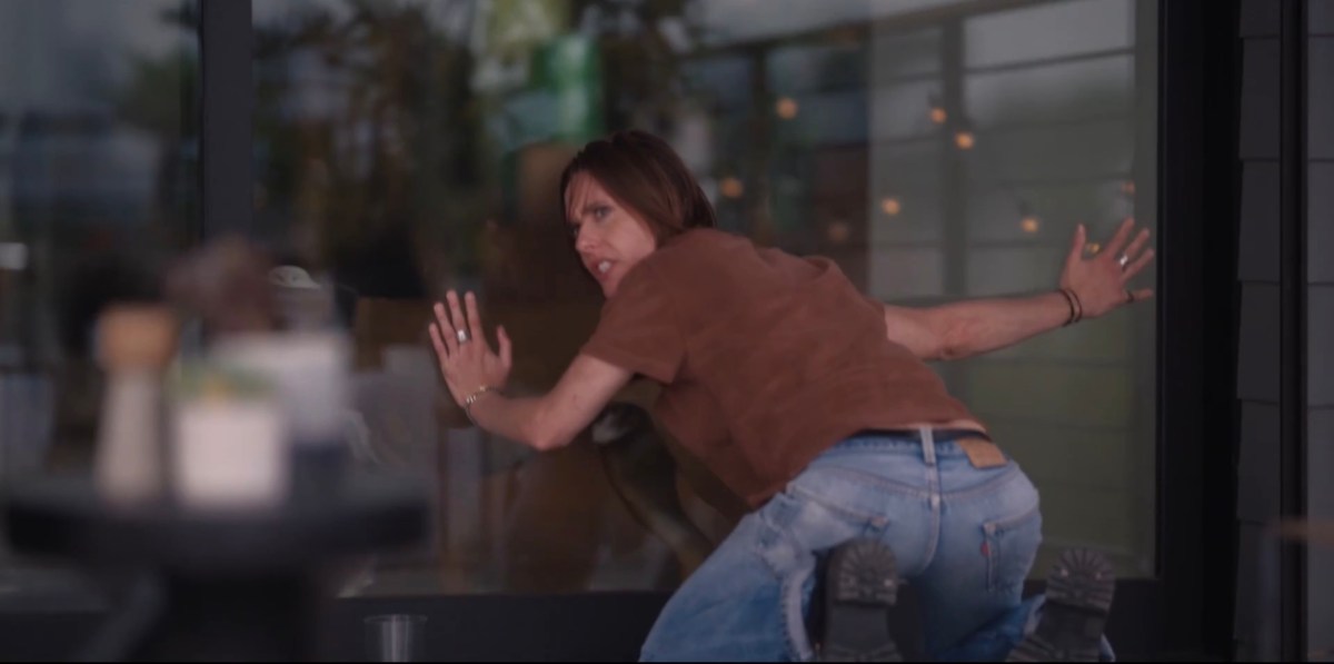 Shane with her hands against the glass and her butt out