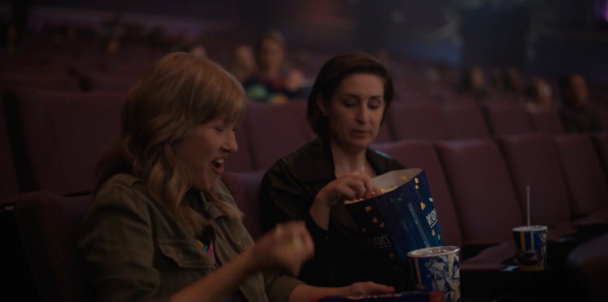 Taylor and her date eating popcorn and laughing