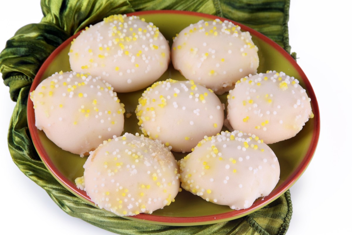 Italian wedding cookies covered with vanilla icing and sprinkles