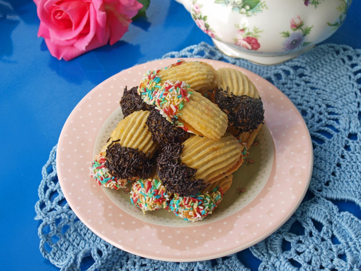 Italian butter cookies dipped in chocolate with sprinkles