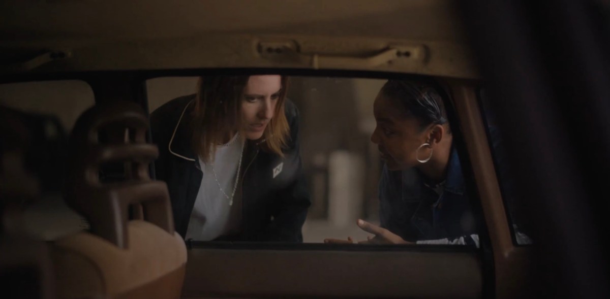 Shane and Angie talking outside the car