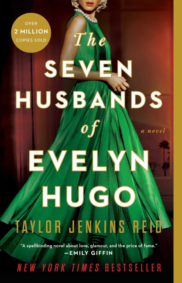 a woman in a green dress is behind the text: the seven husbands of Evelyn Hugo