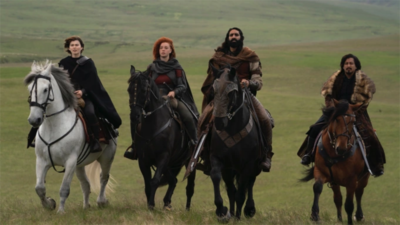 The hero crew sets out to rescue Eric in Willow. They're riding horses across a field. 