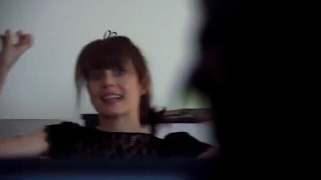 a screenshot of season 6 Jenny from the L Word holding up her fingers and giving scare quotes while freaking out