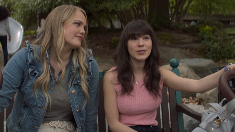 The Watchful Eye: Kim looks lovingly at Alex as they sit on a park bench holding onto strollers