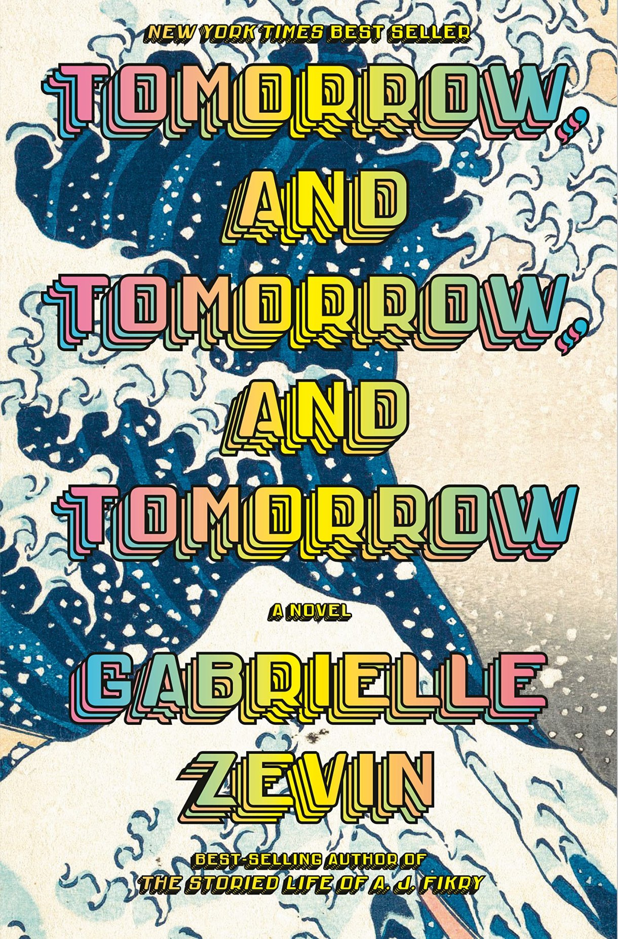 the title tomorrow and tomorrow and tomorrow is in rainbow gradient letters set against an illustration of a crashing, foaming blue wave that is reminiscent of a ukiyo-e print.