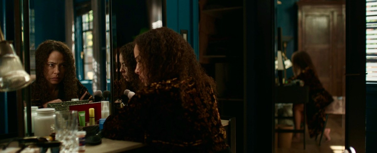 Taissa's reflection glares at her in the mirror