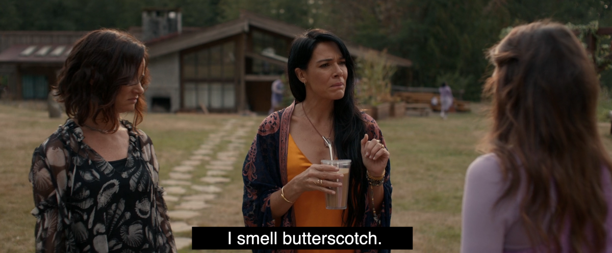 Adult Lottie says "I smell butterscotch" standing next to Nat and Lisa in Yellowjackets 202