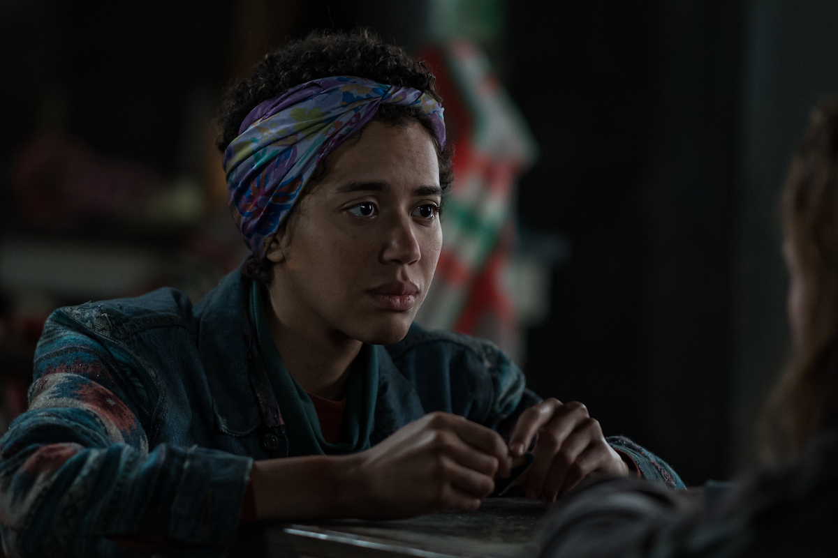 Yellowjackets Jasmin Savoy Brown as Teen Taissa in YELLOWJACKETS Season 2 sits and looks serious. Photo Credit: Kailey Schwerman/SHOWTIME.