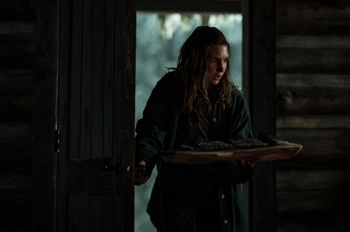 Sophie Nélisse as Teen Shauna in YELLOWJACKETS Season 2 walks into the cabin. Photo Credit: Kailey Schwerman/SHOWTIME.