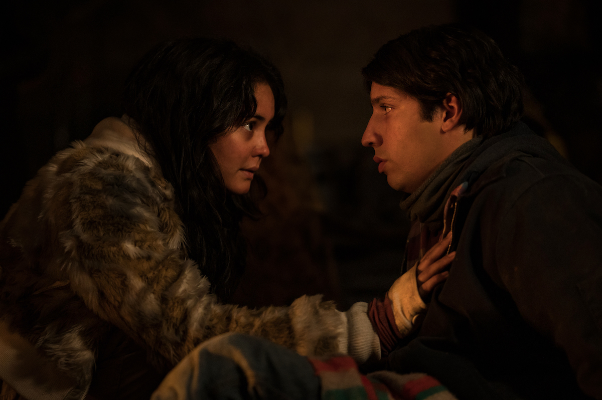 Yellowjackets (L-R): Courtney Eaton as Teen Lottie and Kevin Alves as Teen Travis in YELLOWJACKETS Season 2 are crouched in the cabin. Photo Credit: Kailey Schwerman/SHOWTIME.