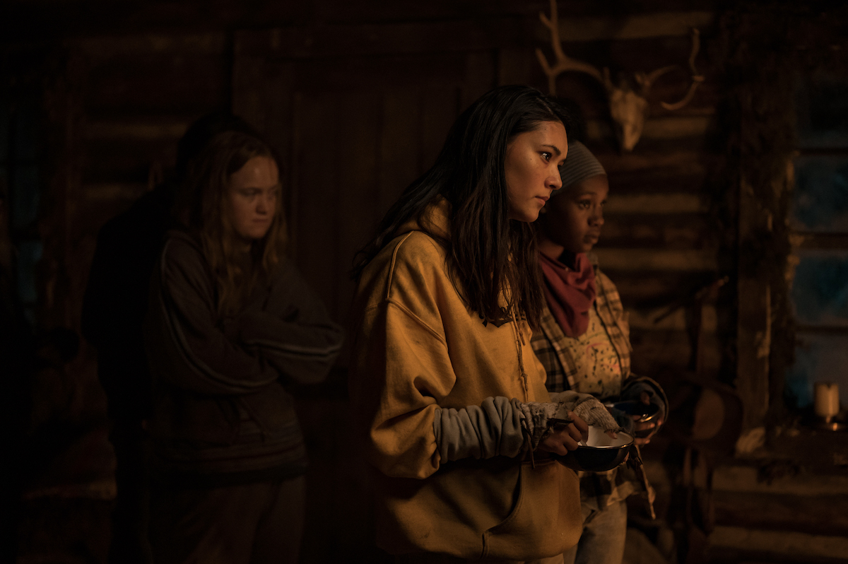 Yellowjackets (L-R): Liv Hewson as Teen Van, Alexa Barajas as Teen Mari and Nia Sondaya as Teen Akilah in YELLOWJACKETS Season 2 are in the cabin, looking at something. Photo Credit: Kailey Schwerman/SHOWTIME.
