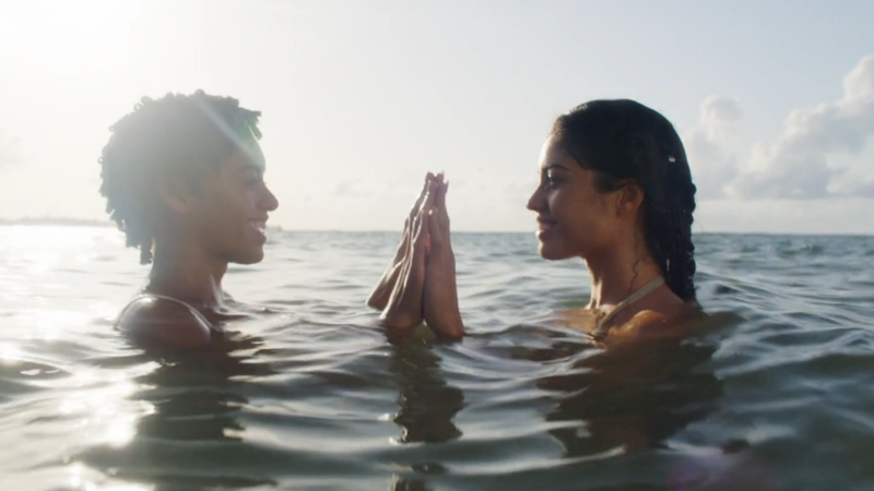 Fantasy Island: Ruby and Isla press their hands together while standing shoulder-deep in the ocean